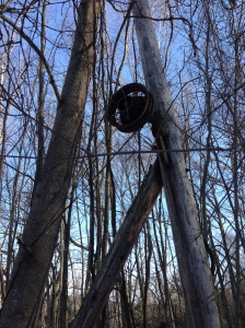 another old rope tow bullwheel on a tree
